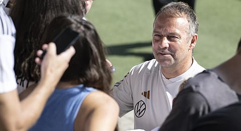 Germany's national soccer coach Hansi Flick signs autographs in Wolfsburg, Germany, Sunday, Sept. 10, 2023. (Photo | PTI)