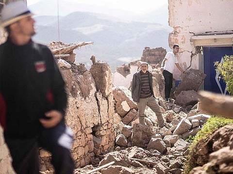 People inspect their damaged homes after an earthquake in Moulay Brahim village, near Marrakech, Morocco. (Photo | AP)