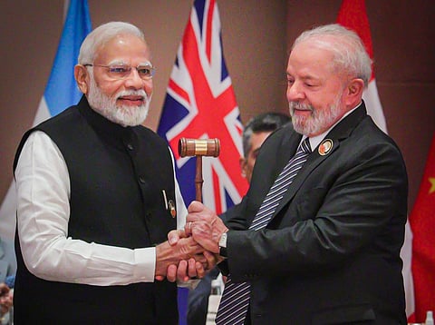 Prime Minister Modi congratulates Brazil's President Luiz Inacio Lula da Silva while handing him over the presidency of G20. (PTI)