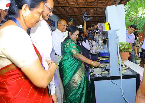 Governor Tamilisai Soundararajan inspects a plate-stamping machine. (Photo | Express)