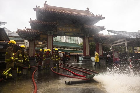 FILE - Fire-fighters drain out water following heavy rainstorms in Hong Kong, Friday, Sept. 8, 2023. (Photo | AP)