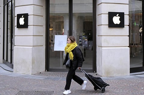 FILE - A woman walks past a closed Apple Store in Lille, northern France, Monday, March 16, 2020. (Photo | AP)