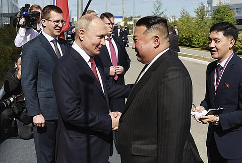 Russian President Vladimir Putin (L) and North Korea's leader Kim Jong Un shake hands outside the Vostochny Cosmodrome in Russia's far eastern Amur region, Sept. 13, 2023. (Photo | AP)