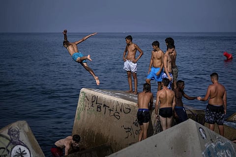 FILE - A man jumps into the sea on a breakwater in Barcelona, Spain, July 12, 2023. (Photo | AP)
