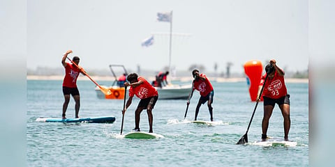 Participants performing in the second edition of the Palkbay SUP Challenge held at pirappanvalasi beach in Ramanthapuram District. (Photo | Express)