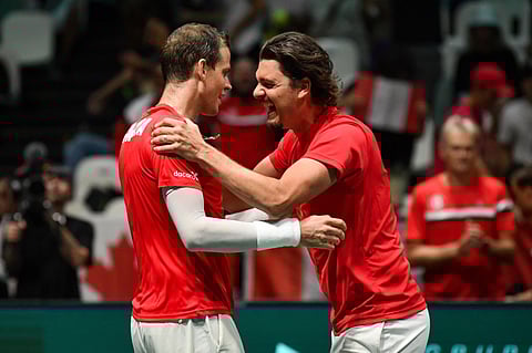 Canada's Frank Dancevic (right) congratulates Canada's Vasek Pospisil after he defeated Sweden's Leo Borg during their Davis Cup group stage tennis match. (Photo | AP)