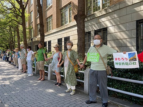 People form a human chain outside of the Ministry of Education, Culture, Sports, Science and Technology on Sunday. (Photo | AP)