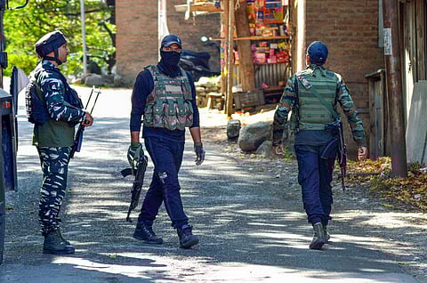 Security personnel guard near the encounter site at Gadol Kokarnag in Anantnag district on September 17, 2023. (PTI)