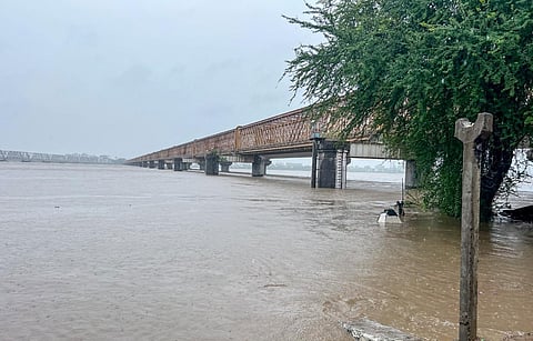 The water level of the Narmada river near Golden Bridge rises to 35 feet due to heavy rains, in Bharuch on Sunday. (ANI)
