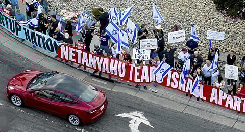 Protesters rally outside Tesla's Fremont, Calif., factory as Israeli Prime Minister Benjamin Netanyahu plans a visit with businessman Elon Musk on Monday, Sept. 18, 2023. (AP Photo)