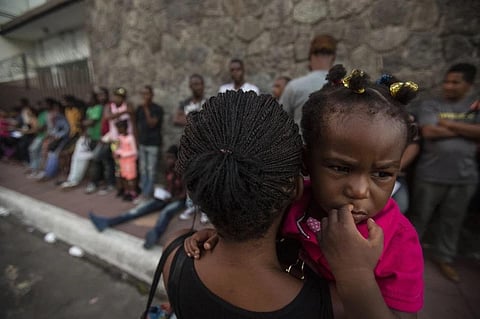 FILE - A Haitian woman carries her daughter as she waits outside the Mexican Commission for Migrant Assistance Office on June 20, 2019. (Photo | AP)