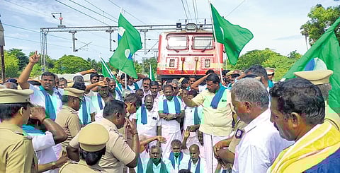 Farmers led by P R Pandian, the general secretary of Tamil Nadu Cauvery Farmers Association, blocking a train at Tiruvarur on Tuesday | Express