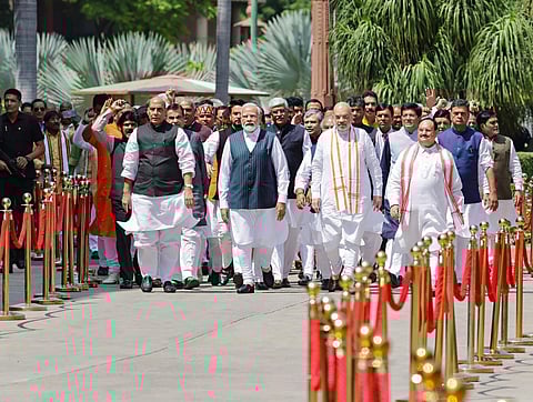 PM Modi with Union Ministers Amit Shah and Rajnath Singh, and other Parliamentarians walk towards the new Parliament building, in New Delhi, on Sept. 19, 2023. (PTI)