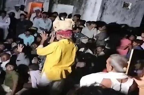 The elderly bhajan singer, Dalchand Balai, was forced to make a public 'apology' while carrying a bundle of shoes on his head. (Twitter)