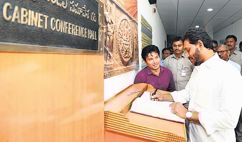 CM Jagan signing the register at the Secretariat in Velgapudi on Wednesday | EXPRESS