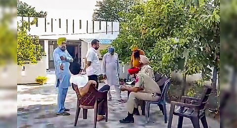 Police officials at the residence of Punjab gangster Sukha Duneke who was killed in inter-gang rivalry in Canada, in Moga district. (Photo | PTI)