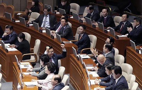 The ruling People Power Party's lawmakers react as the parliament passed a motion to approve main opposition Democratic Party leader Lee Jae-myung's arrest warrant. (Photo | AP)