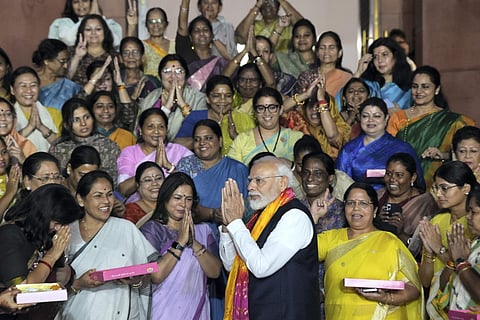 PM Modi flashes victory sign with women MPs after the passage of the Nari Shakti Vandan Adhiniyam (women's reservation bill) by the Rajya Sabha, on Sept 21, 2023. (PTI)