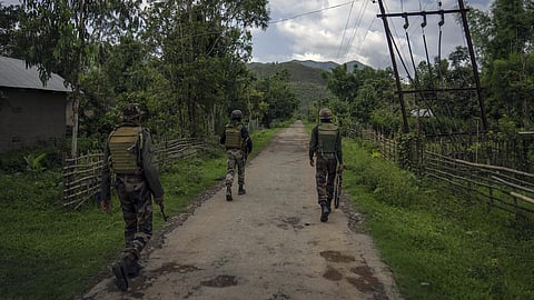 Indian army soldiers patrol a deserted village in Churachandpur, in Manipur.