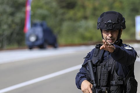 A Kosovo police officer guards a road near the village of Banjska, 55 kilometers (35 miles) north of the capital Pristina, northern Kosovo. (Photo | AP)