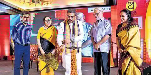 Union minister Dharmendra Pradhan lighting the ceremonial lamp to inaugurate the Odisha Literary Festival, in the presence of the Editorial Director of The New Indian Express Prabhu Chawla (second fro