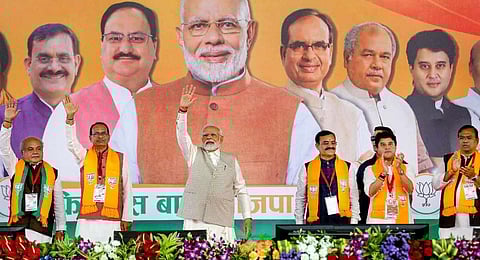 Prime Minister Narendra Modi waves at supporters during BJP's 'Karyakarta Mahakumbh', in Bhopal. Jyotiraditya Scindia and Narendra Singh Tomar, MP CM were also seen.