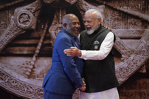 Indian Prime Minister Narendra Modi, right, shares a light moment with African Union Chairman and President of the Union of the Comoros Azali Assoumani upon his arrival at Bharat Mandapam convention c