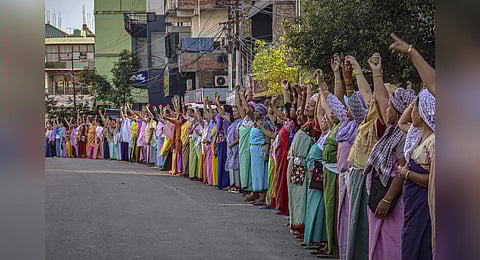 Women form a human chain during a protest, in Imphal, against the killing of two missing students by unknown miscreants and restoration of peace in Manipur, Sept 26, 2023. (Photo | AFP)