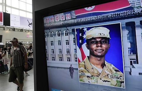 A TV screen shows a file image of American soldier Travis King during a news program at the Seoul Railway Station in Seoul, South Korea. (Photo | AP)
