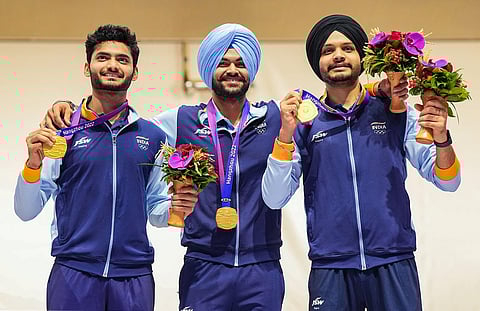Gold medal winning Indian team shooters Sarabjot Singh, Arjun Singh Cheema and Shiva Narwal pose for pictures during presentation ceremony of the men's 10m air pistol event. (Photo | PTI)
