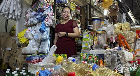 Charina Em poses in one of her food stores in Manila on Thursday. (Photo | AP)
