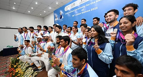 Minister for Youth Affairs and Sports Anurag Thakur with the medallists of the 19th Asian Games during their felicitation ceremony. (Photo | PTI)