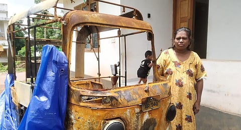 Chithralekha near her burnt down autorickshaw