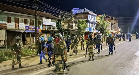 RAF and CRPF personnel guard after a mob tried to attack the ancestral house of Chief Minister N Biren Singh at Heingang in Imphal. (Photo | PTI)