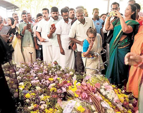 An elderly woman at Oommen Chandy’s tomb at Puthuppally church in Kottayam | Pics: T P Sooraj