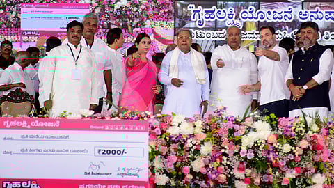 AICC president Mallikarjun Kharge, Congress leader Rahul Gandhi, CM Siddaramaiah and Deputy CM D K Shivakumar at the launch of the Gruha Lakshmi scheme in Mysuru