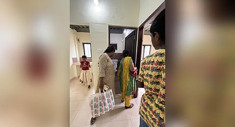 Residents of P&T Colony taking a look at their new house at Mundamveli
