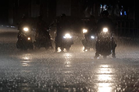 Riders wait at the intersection under heavy rain as the Typhoon Haikui approaches the country, in Taipei, Taiwan. (Photo | AP)