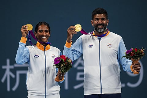 India's Rutuja Bhosale and Rohan Bopanna celebrate with their gold medal after the tennis mixed doubles final at the 19th Asian Games in Hangzhou, China, Saturday, Sept. 30, 2023. (Photo | AP)