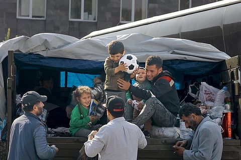 Ethnic Armenian family from Nagorno-Karabakh are helped to leave a truck with their belongings after arriving to Armenia's Goris in Syunik region. (Photo | AP)