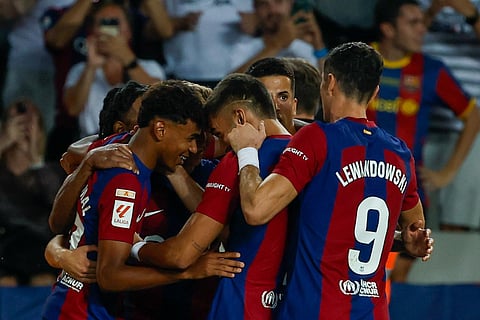Barcelona players celebrate after Sevilla's Sergio Ramos scores an own goal past his goalkeeper. (Photo | AP)