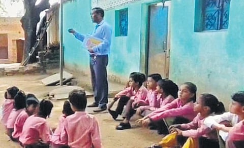 In order to check absenteeism at government primary school, Amit Verma took the class at the house of a student who was absent, in Badagaon, Jhansi, UP | express