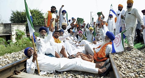 Punjab Mazdoor Sangharsh Committee activists raise slogans as they block railway tracks during a protest demanding flood compensation, MSP guarantee law and debt relief. (Photo | PTI)