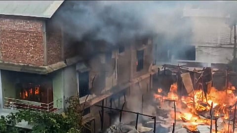Representational Image: Smoke billows out of a house after unidentified miscreants burnt three houses, in Imphal, Sunday, Aug. 27, 2023. (Photo | PTI)