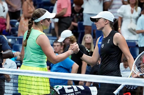 Jelena Ostapenko (left) shakes hands with Iga Swiatek at the end of the match, won by Ostapenko, in the fourth round of the U.S. Open tennis championships. (Photo | AP)