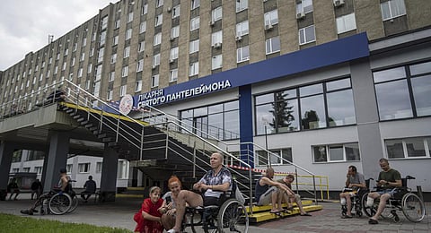 Ukrainian army veterans rest with their families and comrades outside St. Panteleimon hospital in Lviv, Ukraine. (Photo | AP)