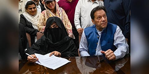 FILE - Imran Khan (R) along with his wife Bushra Bibi (L), who signs surety bonds for bail in various cases, at the High Court, in Lahore on July 17, 2023. (Photo | AFP)