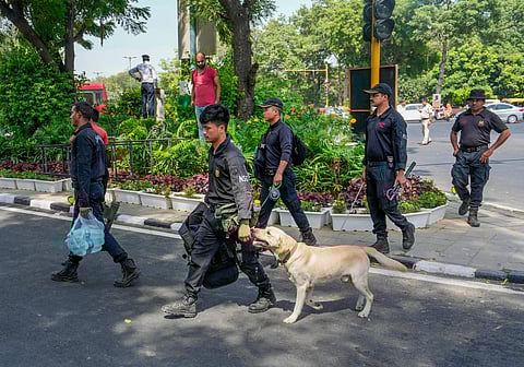 Security personnel with a sniffer dog conduct security checks near Rajghat in preparation for the upcoming G20 Summit (Photo | PTI)