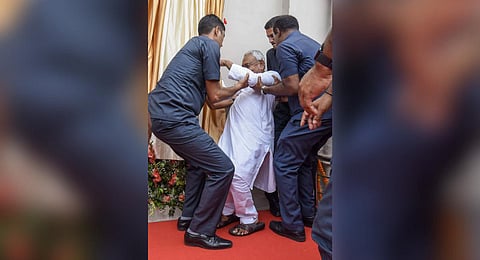 Bihar CM Nitish Kumar being assisted after he lost his balance during the inauguration of the renovated Wheeler Senate House of Patna University. (Photo | PTI)