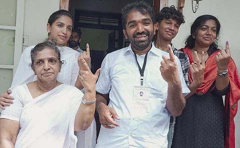 Chandy Oommen with family members after casting vote during bypolls at Puthuppally, in Kottayam district. (Photo | PTI)